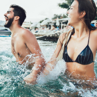 Sexy,Young,Couple,On,The,Beach,Having,Fun